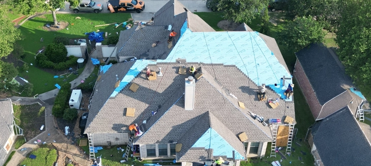 TX Roofing crew installing underlayment and shingles across the same roof