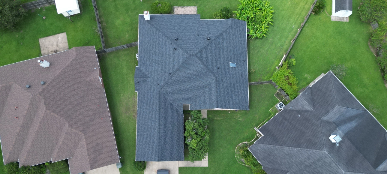 Top-down aerial view of a home with a skylight and a new blue-gray shingle roof